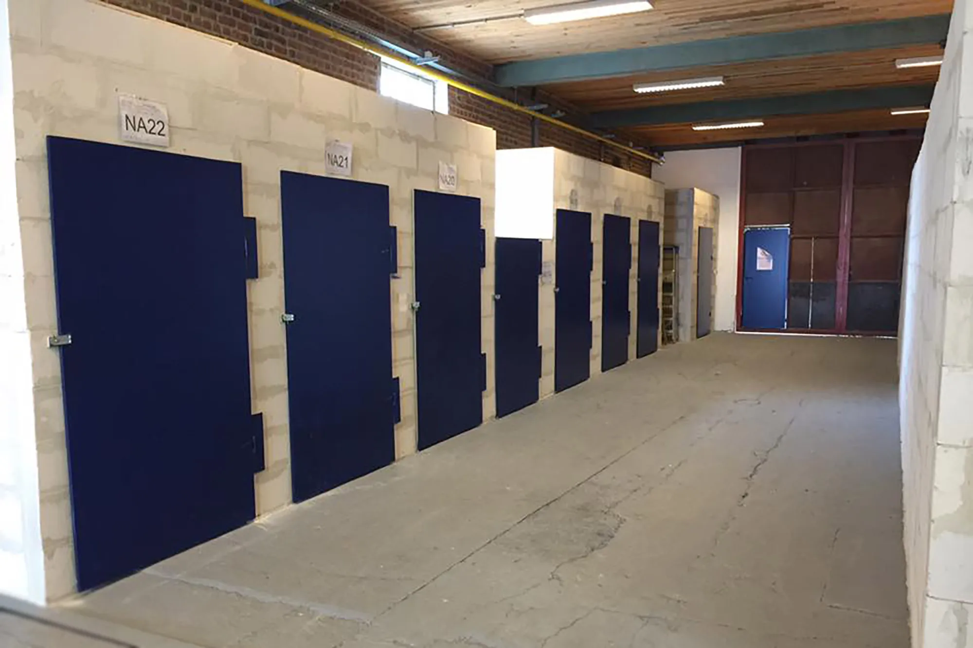 Rangée de box à portes bleues dans un entrepôt Euro Renting Box